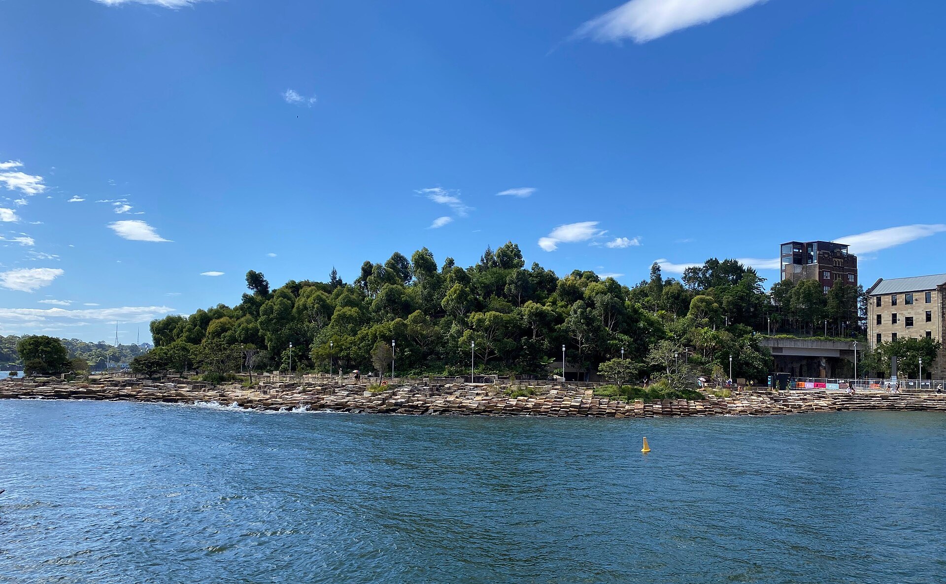 The rebuilt sandstone shoreline of Barangaroo Reserve from the harbour