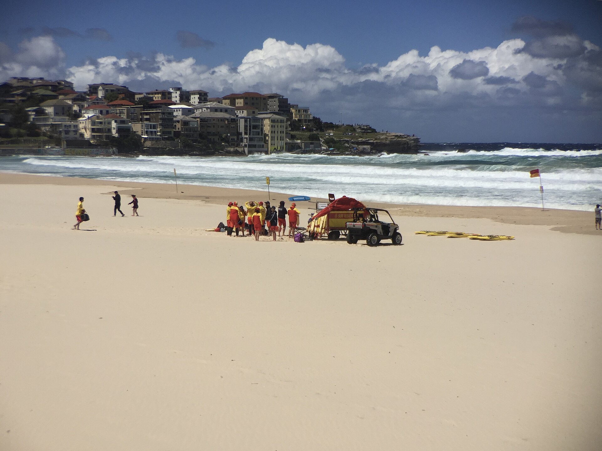 Surf lifesavers and their vehicle on the sand at Bondi