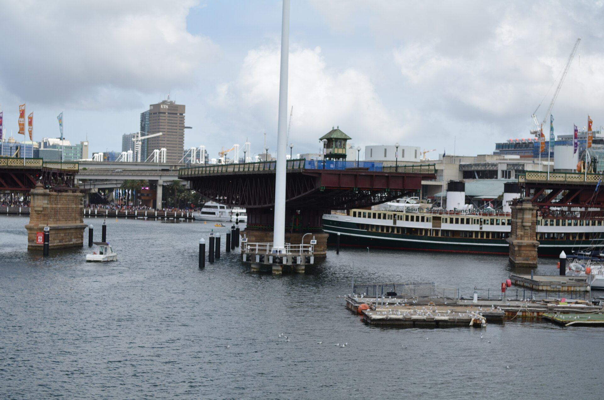 Pyrmont Bridge closed to the water, a vessel moored beside its stone piers