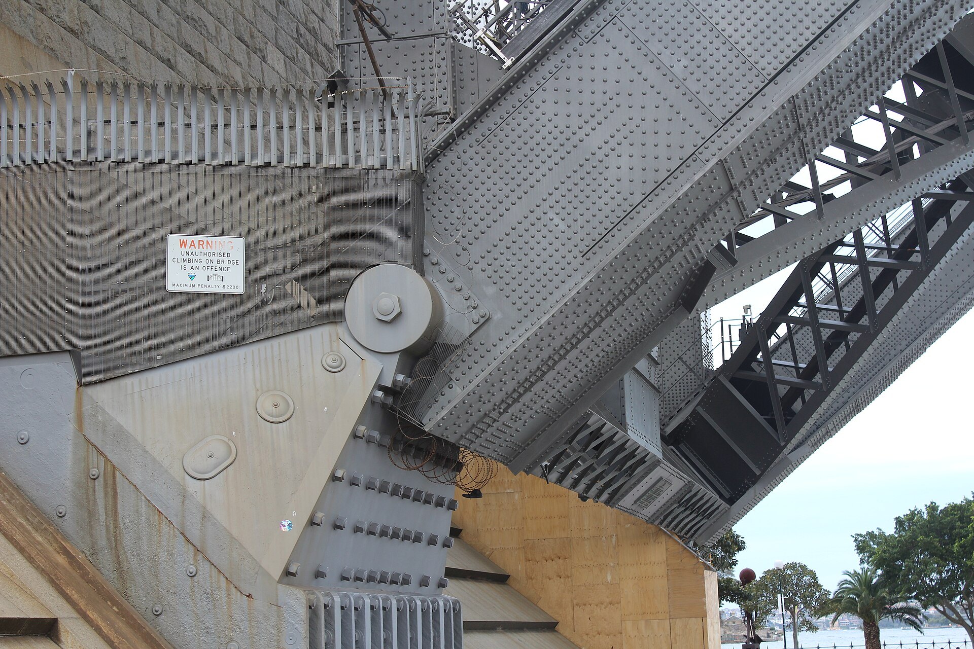 A riveted steel hinge where the bridge arch meets its bearing
