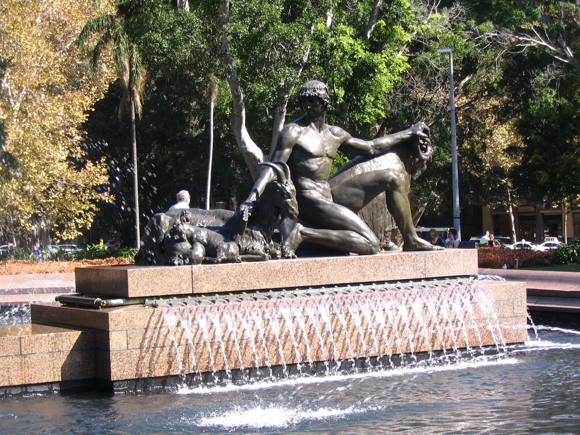 Bronze sculpture at the side of the Archibald Fountain, water running over the basin
