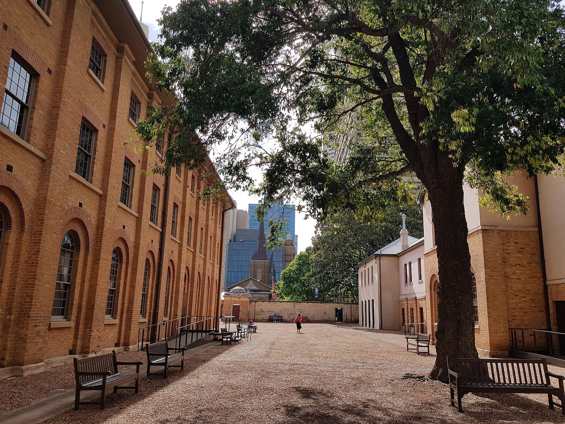 The courtyard inside the barracks, a tree and benches along the brick wall