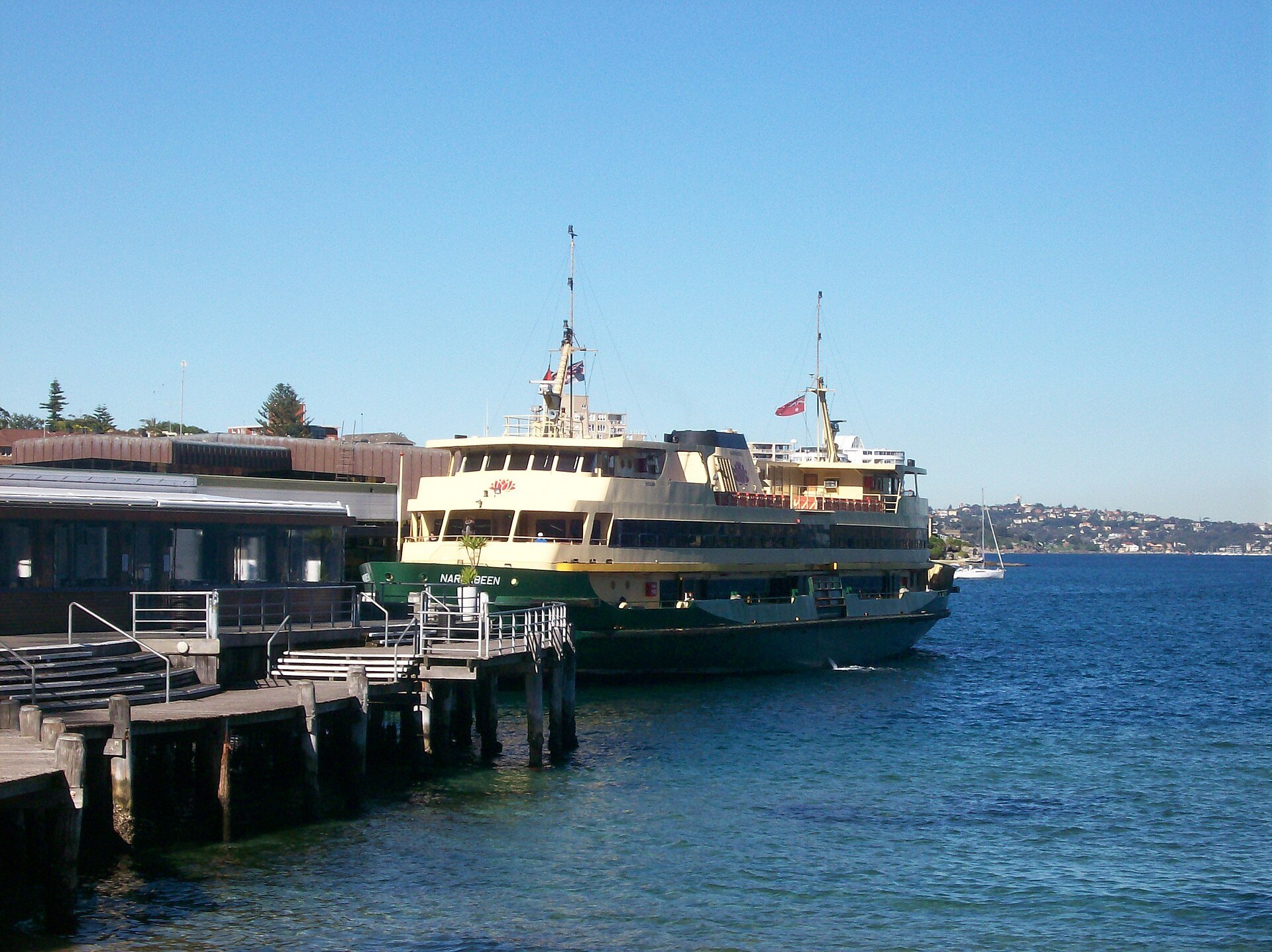 A Sydney ferry moored at Manly wharf with passengers boarding