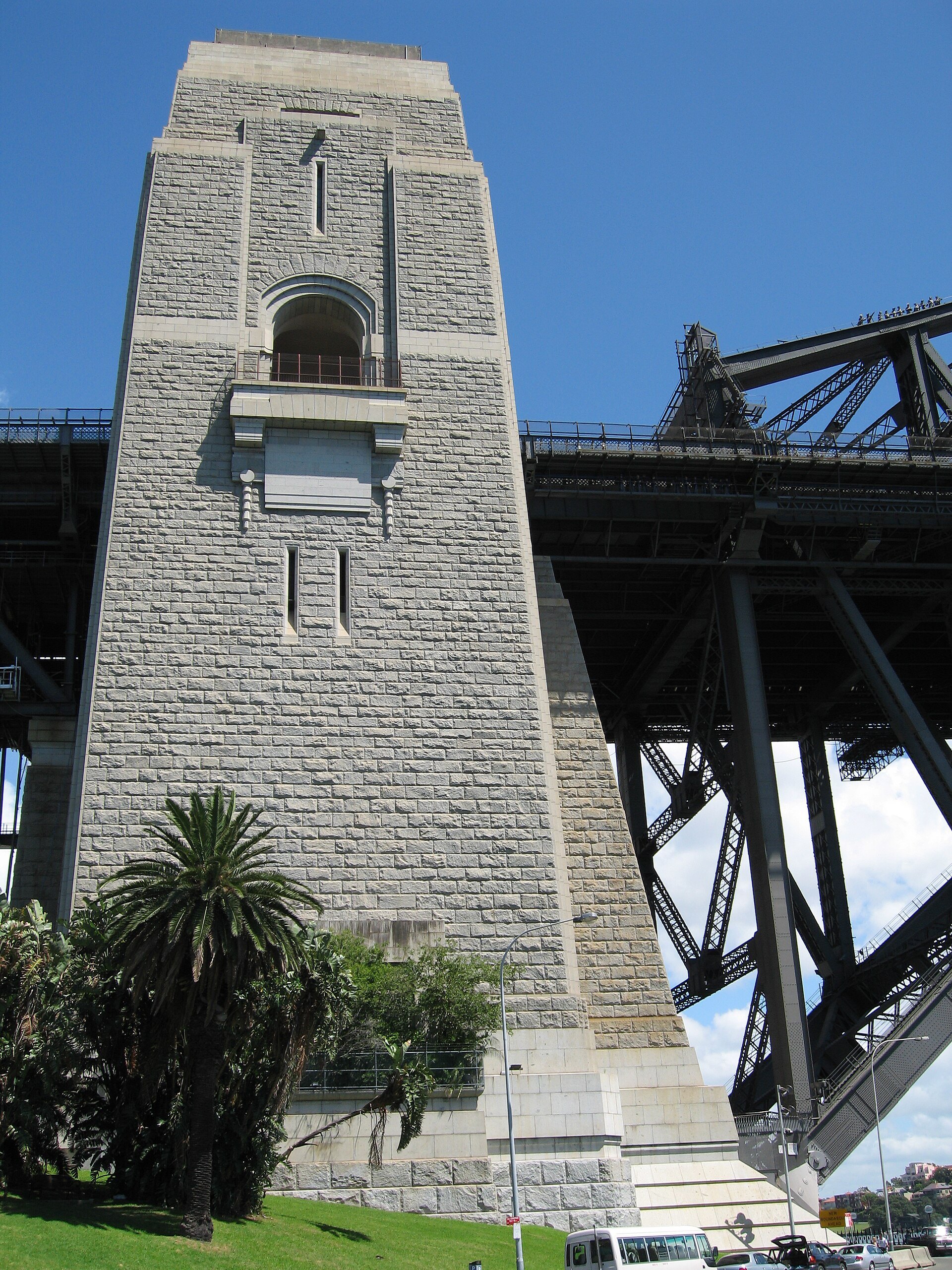 The stone pylon of the Harbour Bridge seen from below beside the steel span