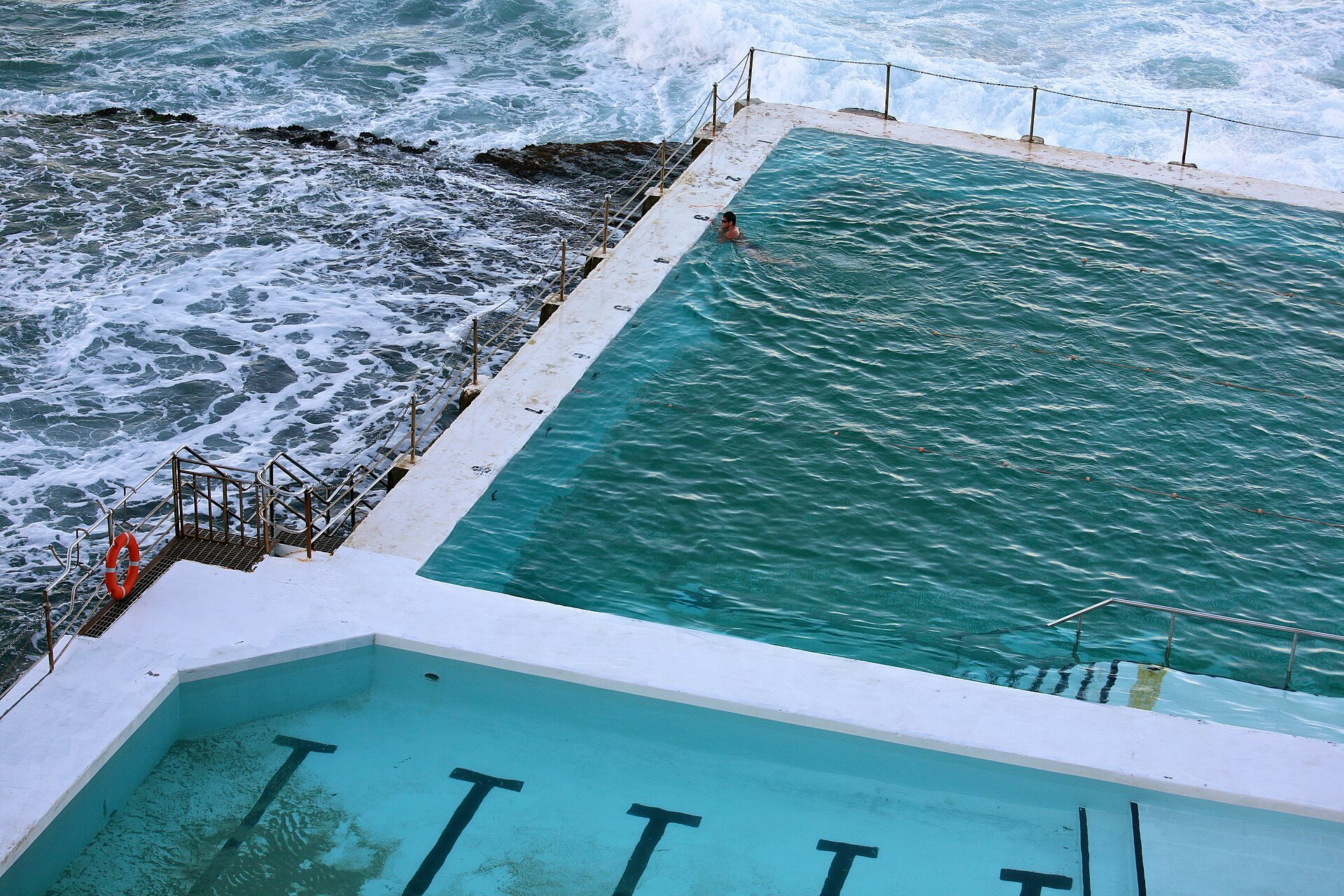 The Bondi Icebergs ocean pool with surf breaking over its wall