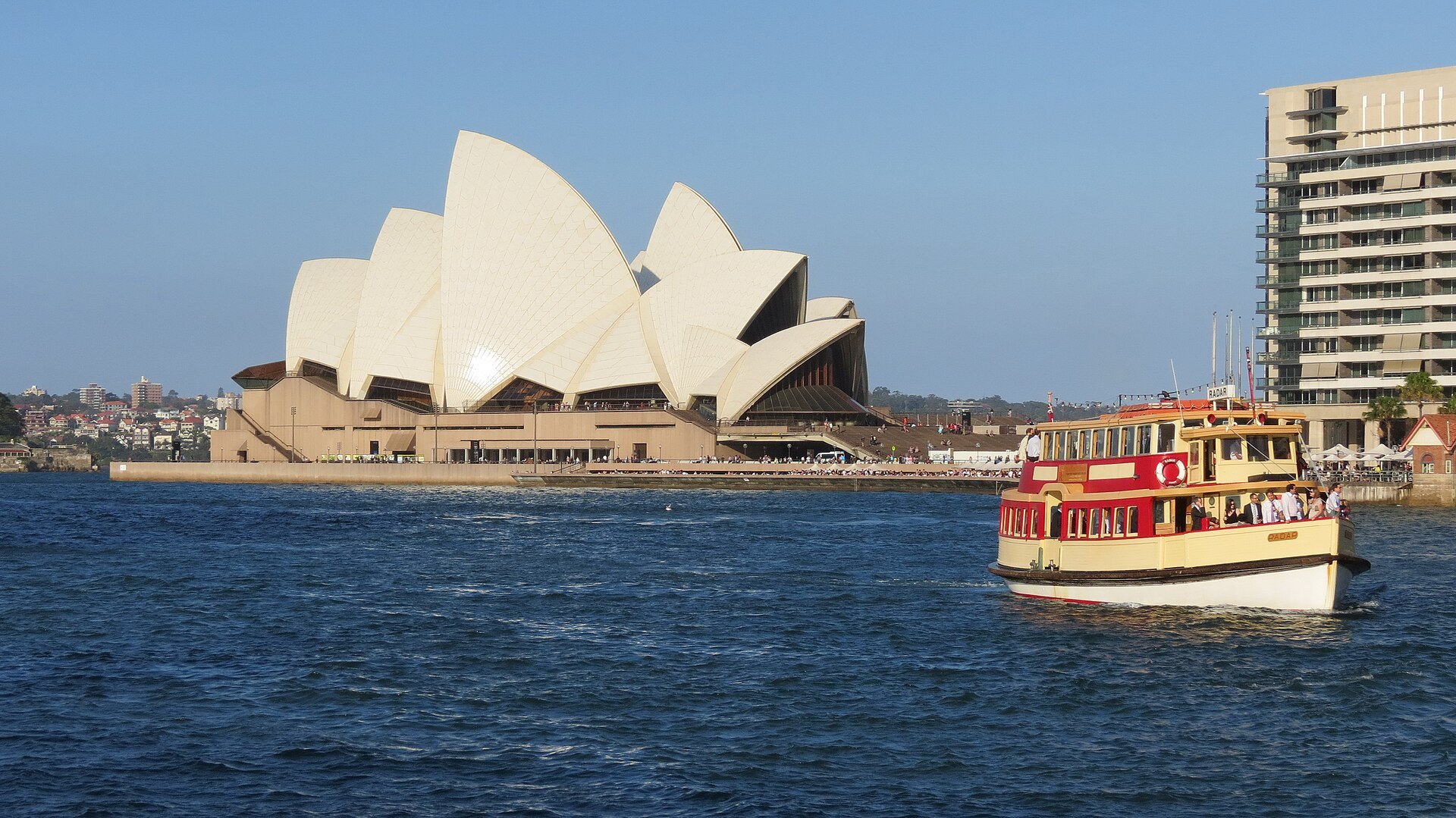 The Opera House across the water at Circular Quay with a ferry passing in front of it